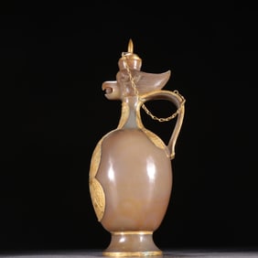 A piece of Liaojin agate wrapped with gold phoenix head pot