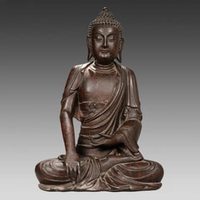 A Qing Dynasty wood carved rhino leather lacquer statue of Shakyamuni Buddha