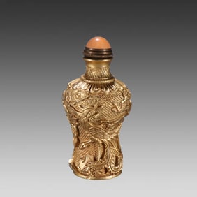 A copper-gilt engraved snuff bottle with a floral and bird-patterned pattern