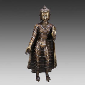 A 17th-century bronze statue of a bronze Buddha inlaid with silver