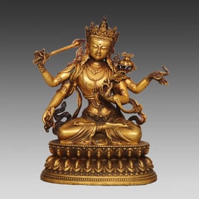 A four-armed Manjushri ornament in copper gilt