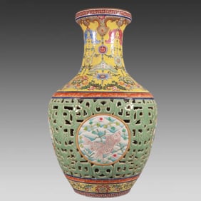 A delicate pastel yellow ground bean green glazed hollow carved fish bottle