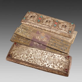 A gilt silver scripture of brass
