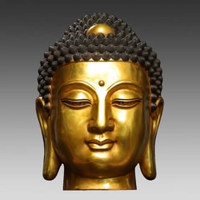 A bronze gilt Buddha head statue