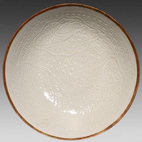 A Song Dynasty Dingbaokou kiln carved flower and bird pattern plate