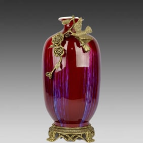 A kiln-glazed flower, bird, and plum vase inlaid with copper