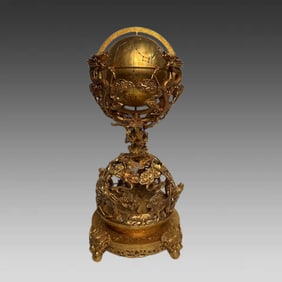 A bronze gilt globe ornament of a coiled dragon