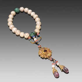 A Qing Dynasty pearl longevity pattern eighteen sons held