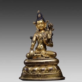 A bronze gilt statue of Guanyin holding a lotus in the Qing Dynasty