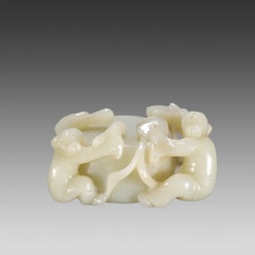 A Qing Dynasty boy drumming ornament of Hetian jade