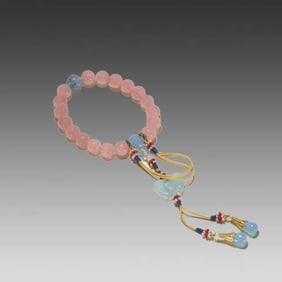 A piece of old pink quartz with aquamarine handheld