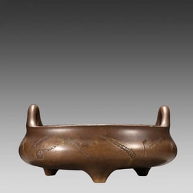 A three-legged incense burner made of copper
