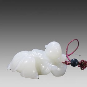 A Qing Dynasty carving of a fortune-giving boy from Hetian jade