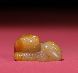 A small jade tiger ornament by Huang Qin