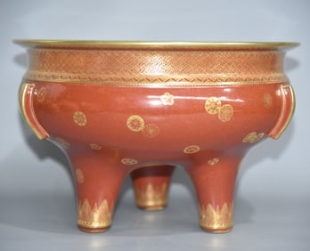 A piece of rust glazed three-legged tripod painted gold ball flower