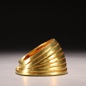 A piece of copper-gilt horseshoe gold