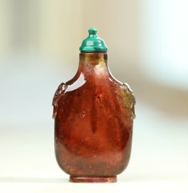 An old tourmaline caramel-colored tourmaline beast head ring snuff bottle