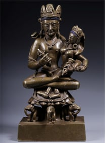 A Qing Dynasty alloy bronze King Kong holding a double-body Buddha statue