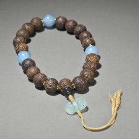 An old agarwood with aquamarine handheld
