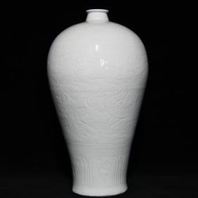 A Yuan Dynasty shadow blue glaze carved dragon pattern plum vase