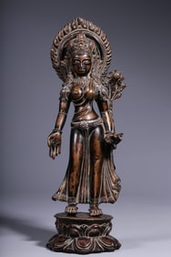 A bronze statue of Guanyin holding a lotus from the Qing Dynasty