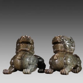 A pair of Hetian blue and white seed material lion ornaments from the Qing Dynasty