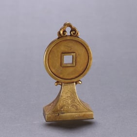 A bronze gilt coin stamp