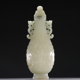 A piece of Hetian jade seed material carved in the Qing Dynasty is a double dragon ear bottle with a