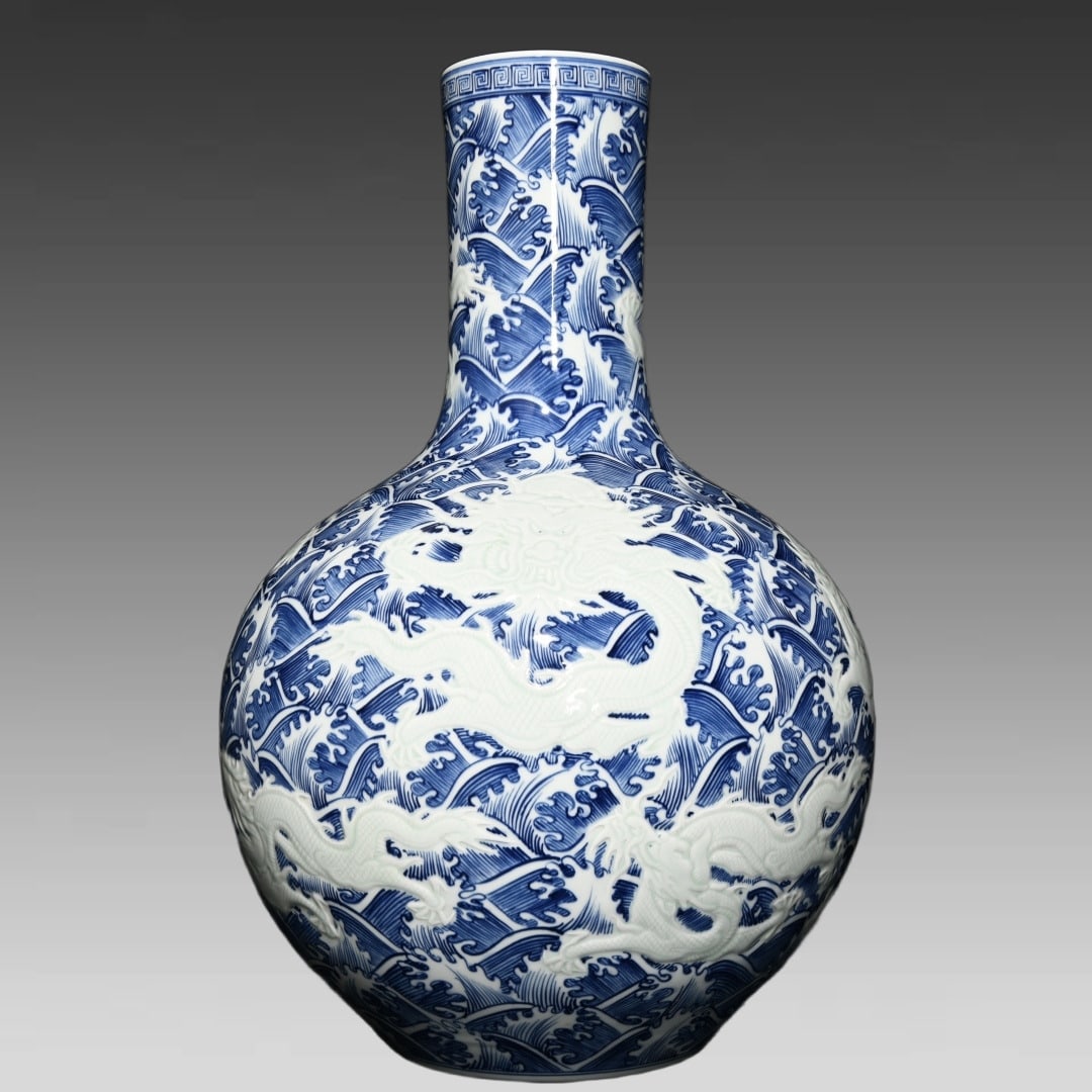 A blue and white relief seawater dragon pattern celestial ball bottle made in the Yongzheng year of: Qing Dynasty Yongzheng year made blue and white relief seawater dragon pattern celestial ball bottle Size:H:59cm D:39cm (The Dimensions Of All Batches Are Manually Measured.If You Need More Detailed I