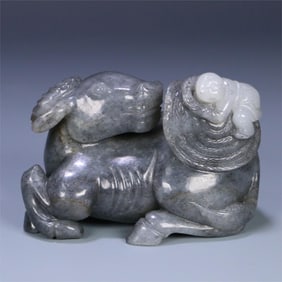 A Qing Dynasty Hetian jade blue and white seed material boy cattle ornament