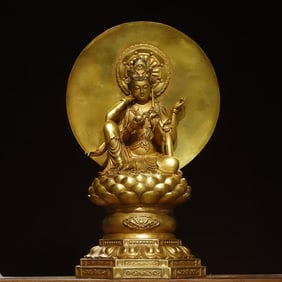 A bronze gilt six-armed statue of Guanyin Buddha