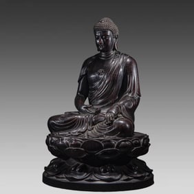 A seated statue of a rosewood Buddha from the Qing Dynasty