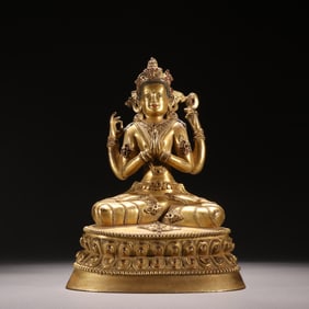 A Qing Dynasty bronze gilt four-armed Guanyin statue