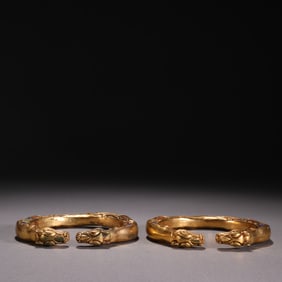 A pair of bronze gilt beast pattern bracelets from the Qing Dynasty