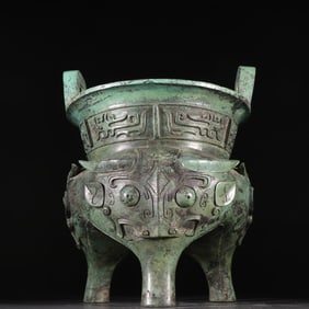 A bronze beast-faced tripod