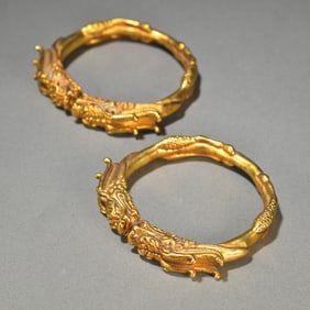 A pair of bronze gilt auspicious dragon bracelets