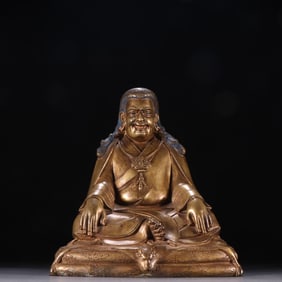 A bronze gilt Marpa seated statue from the Qing Dynasty
