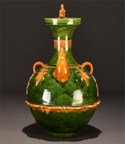 A green glazed dragon and phoenix pattern holding pot from the Tang Dynasty