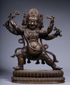 A Qing Dynasty alloy copper inlaid silver three-sided four-armed statue of the Great Black Sky