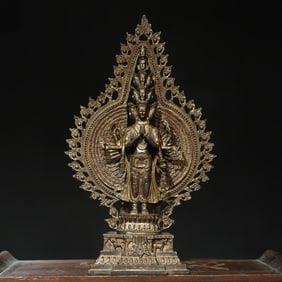 A bronze and gold statue of the thousand-armed Guanyin Buddha
