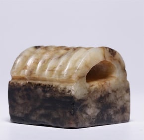 A piece of the ancient bridge shaped button seal