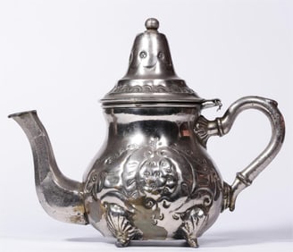 A silvered baroque floral motif holding pot