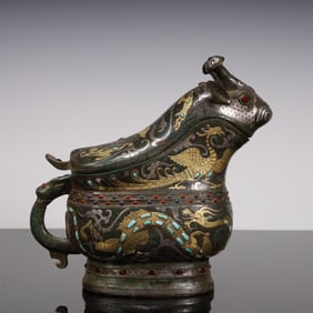 A Han Dynasty cuo gold and silver ox head pot