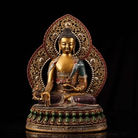 A relief engraving and painted gold Tibetan Medicine Buddha statue