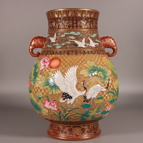 A Qing Dynasty Qianlong year enamel carved gold crane pattern elephant ear vase