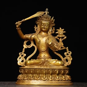 A bronze gilt statue of Manjushri Buddha