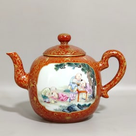 A Qing Dynasty Qianlong year coral red painted gold window baby play teapot