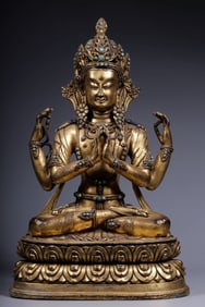 A bronze gilt turquoise four-armed Guanyin seated statue from the Qing Dynasty
