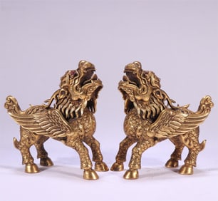 A pair of Qing Dynasty gilt copper-gilt gem-encrusted unicorns