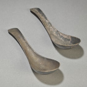 A pair of old sterling silver dragon and phoenix spoons